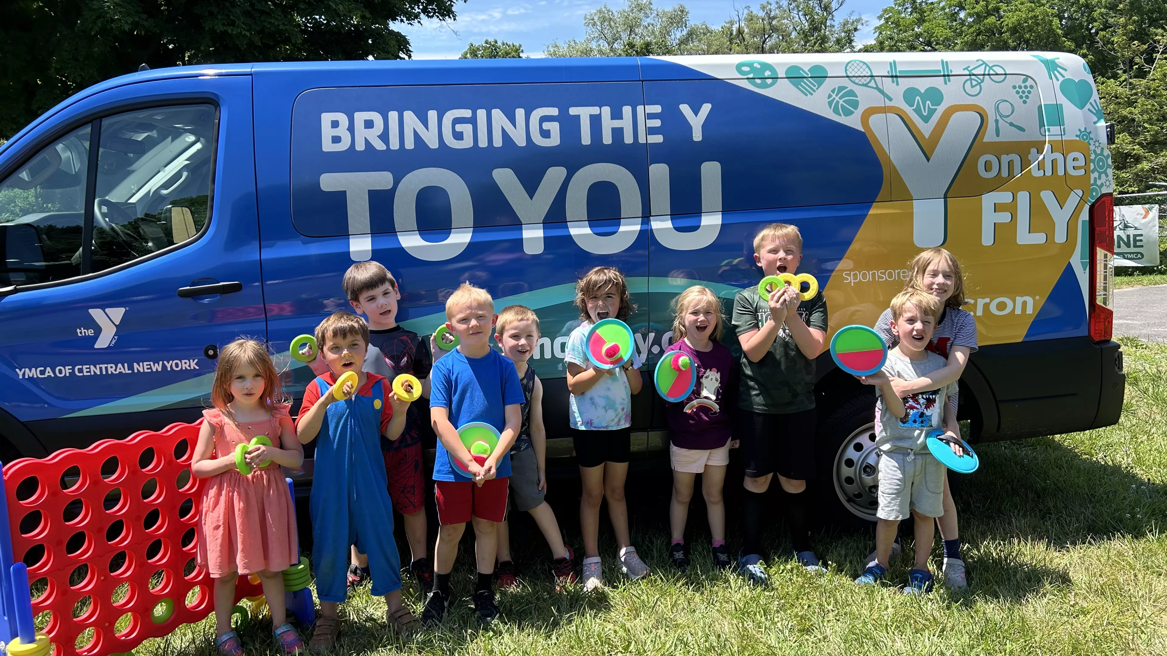 Children next to the Y on the Fly van