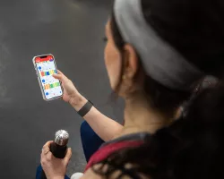 Person checks their MyZone app on their phone.