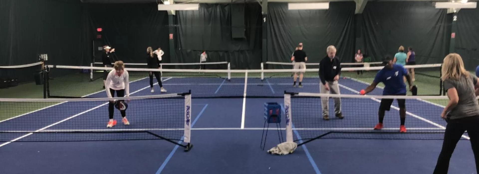 People playing pickleball on a new court